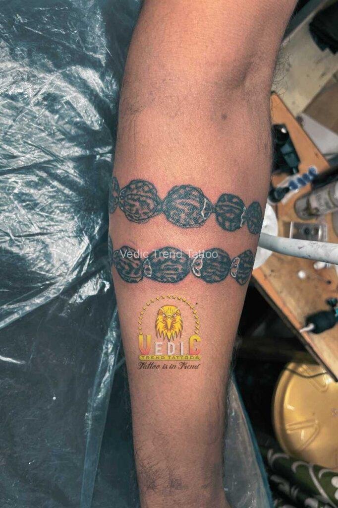 rudraksha-forearm-band-tattoo-design on men hand