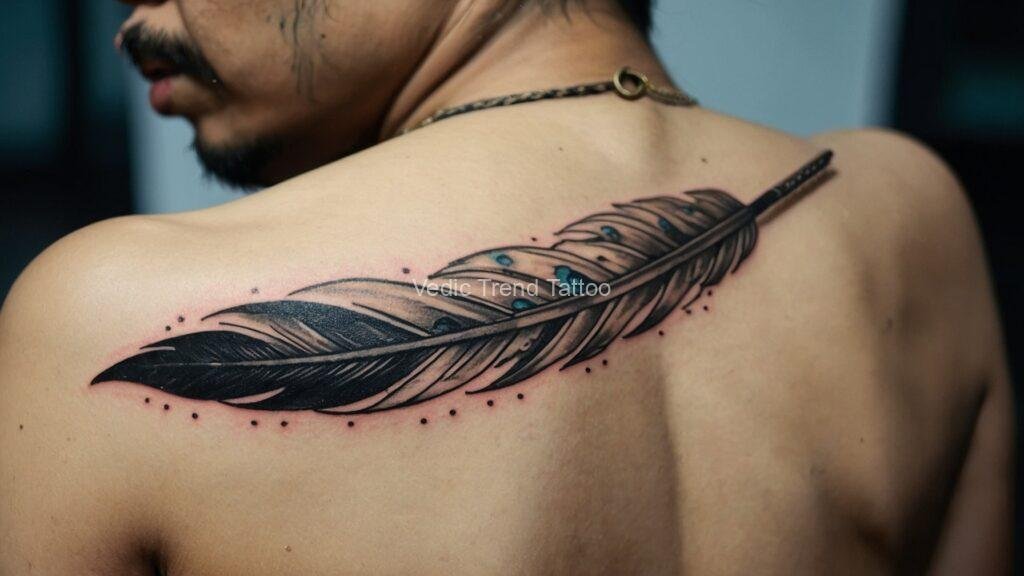 Feather tattoo design on a man's back with Vedic trend elements